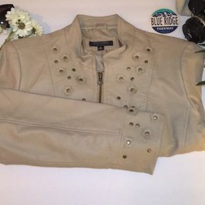 Tan leather jacket with flower decor.